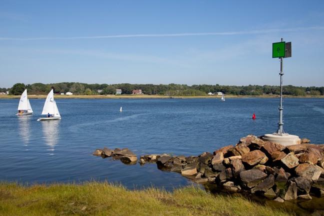 coast on the biddeford campus with two sailboats in the water