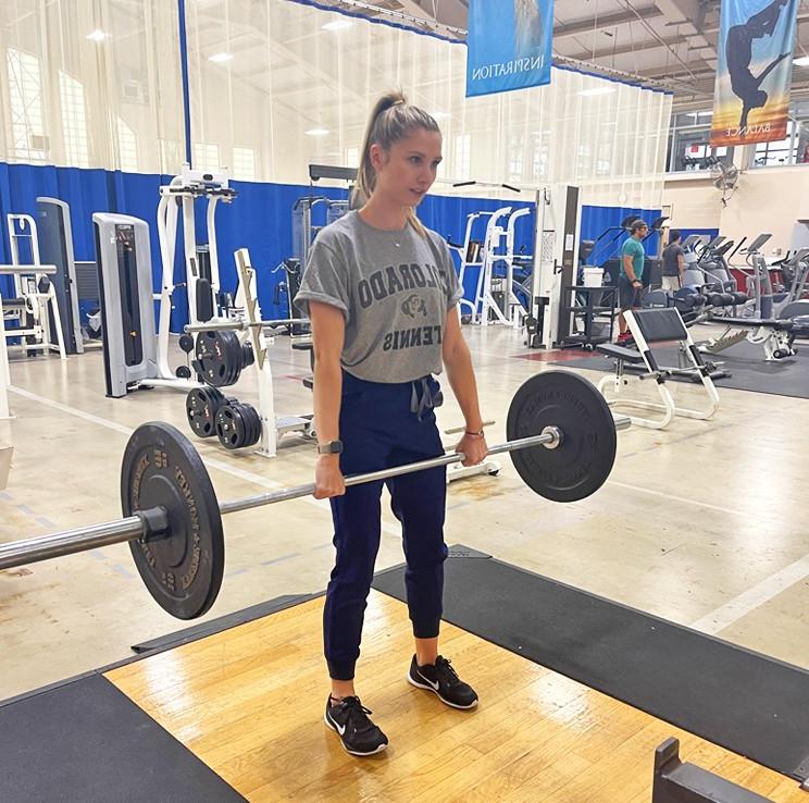 A student performing a Romanian 硬举 with a barbell