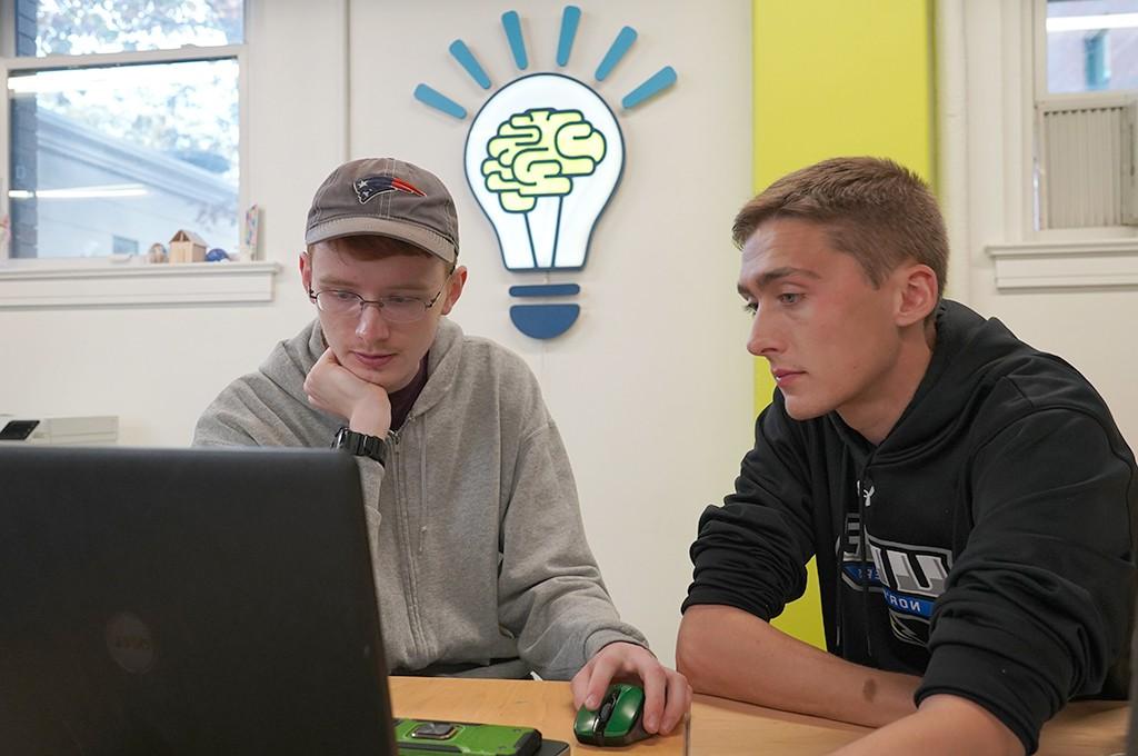 Image of students in the makerspace working on laptops