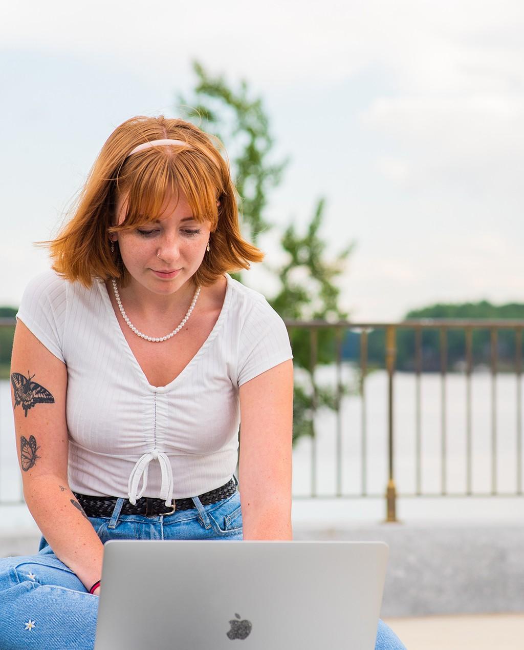 Image of student with laptop outside